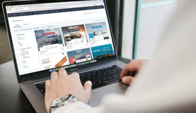 A person using a laptop, likely for work or online activities